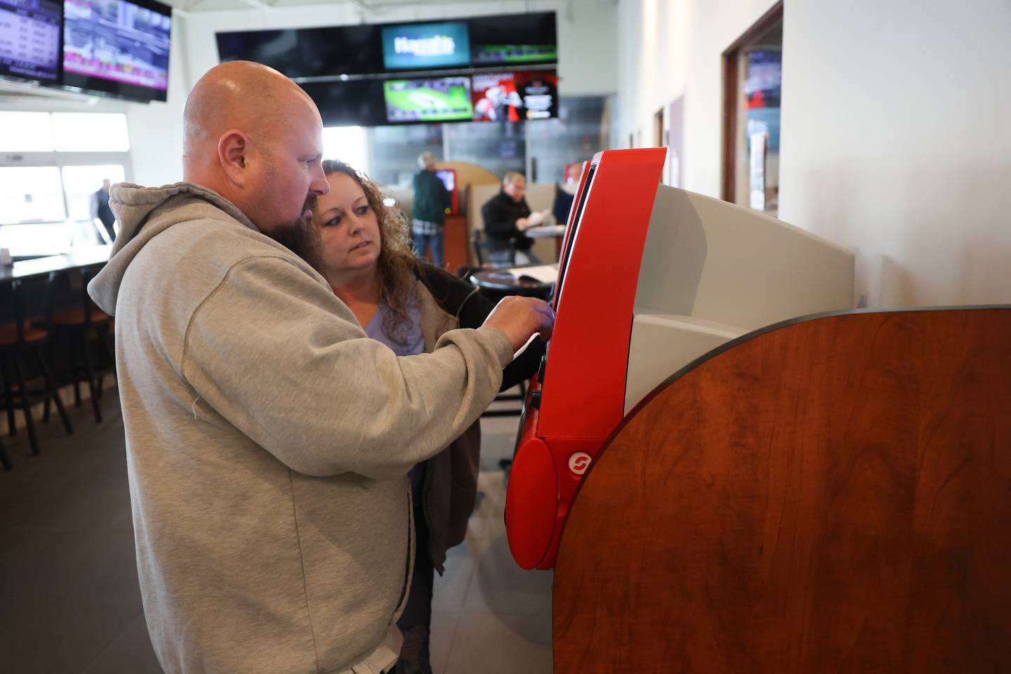 Terry and Spring Holly, of Sandwich, place a bet on the off-track betting kiosk at the new Club Hawthorne at Black eyed Susan in Joliet. Friday, May 6, 2022, in Joliet.