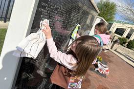 Student volunteers assist in Middle East Conflicts Wall Memorial clean up