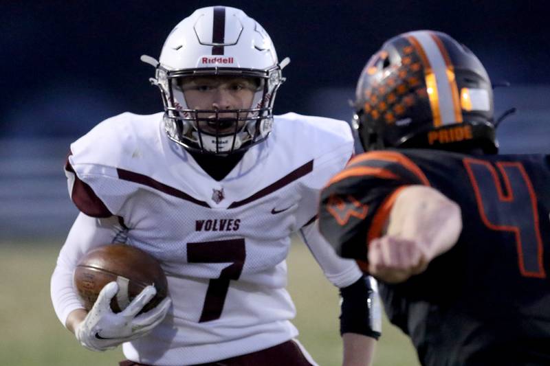 Prairie Ridge'sTyler Vasey runs the ball before taking a hit from Crystal Lake Central's Jake Coss during their football game at Crystal Lake Central High School on Thursday, April 1, 2021 in Crystal Lake.