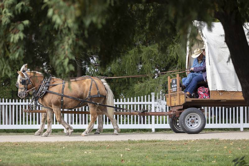 A horse drawn wagon makes its way around the John Deere Historic Site Saturday, October. 12, 2024, as visitors could catch a ride at the Fall Fest. The two day event featured food, fun, games and music set where John Deere set up his homestead and blacksmith shop in 1836 in Grand Detour.