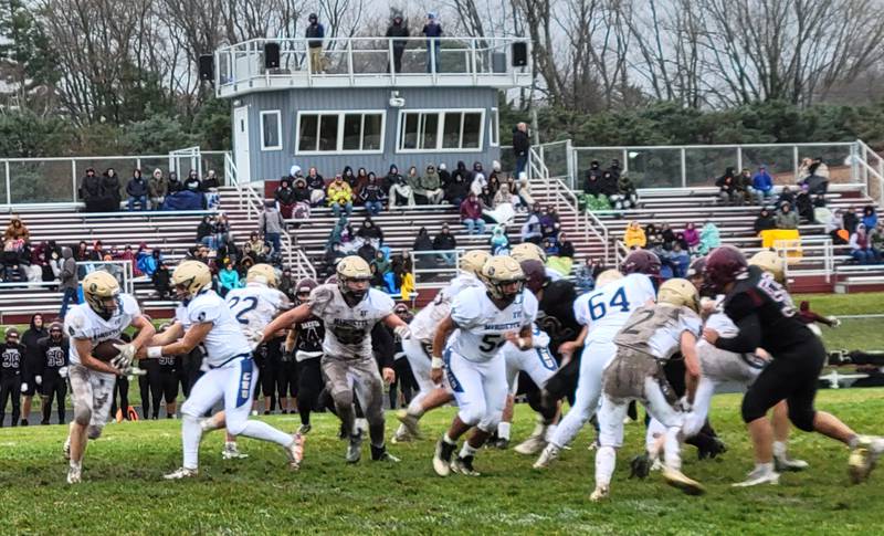 Marquette back Tommy Durdan takes a hand-off from quarterback Alex Graham during Saturday's 1A playoff game at Dakota.