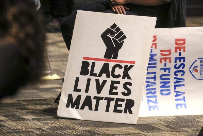 A "Black Lives Matter" sign can be seen Thursday, Aug. 6, 2020, during a combined meeting of the Land Use & Legislative Committee and Public Safety Committee addressing police reform at City Hall in Joliet, Ill.