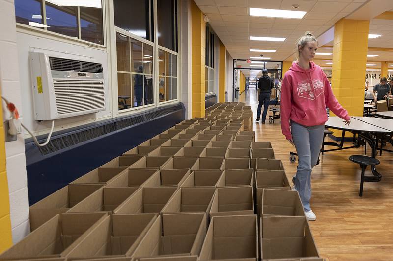 Leah Cochrane of AFC lines up boxes for the food Wednesday, Nov. 6, 2024, at Sterling High School.