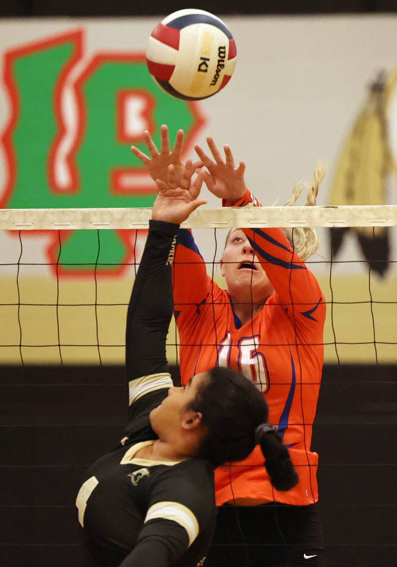Genoa-Kingston's Alayna Pierce blocks the tip of Sycamore's Hatie-Jane Alexander during their match Monday, Aug. 28, 2023, at Sycamore High School.