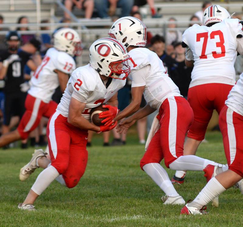 Oregon quarterback Benny Olalde hands the football off to Cooper Johnson during a practice game with Eastland-Pearl City on Friday, Aug. 22, 2025 at Lanark. The Hawks open the 2025 season at Genoa-Kingston on Friday, Aug. 29.