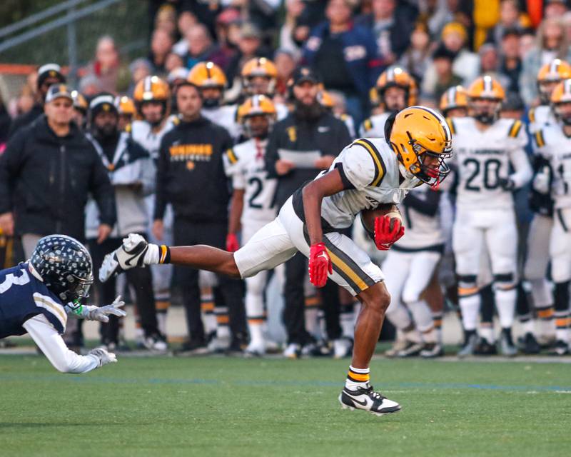 St Laurence's Robert Francis (8) runs by IC Catholic Prep's Kaleb Ellis (3) during Class 4A third round playoff football game between St Laurence at IC Catholic Prep.  Nov 11, 2023.