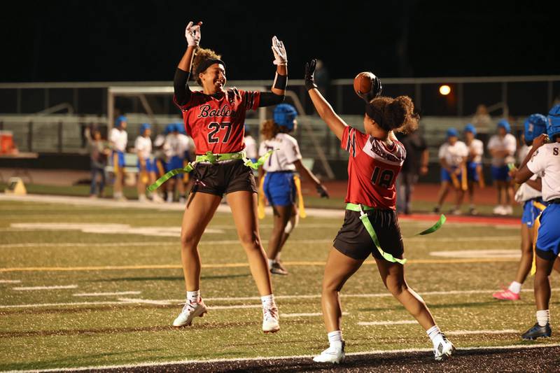 Bradley-Bourbonnais' Alayna Sykes, left, celebrates a touchdown by Nia Lawrence, right, during the Boilermakers' 60-7 victory over Joliet Central in the season opener on Aug. 25, 2025.