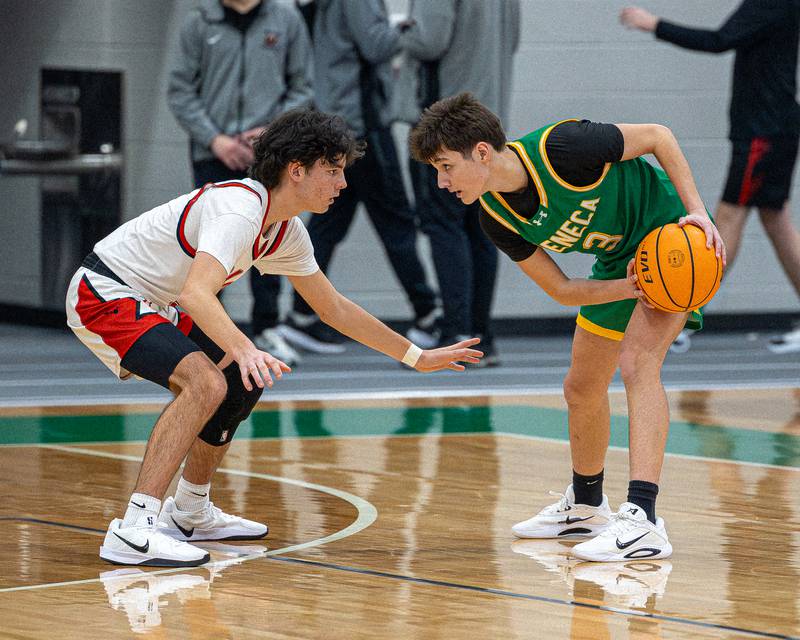 James Zydron (3) of Seneca holds ball contemplating next move as Noah Plym (3) of Hall guards him during game in the Shipyard Showdown on Tuesday, December 23, 2025 at Seneca High School in Seneca.