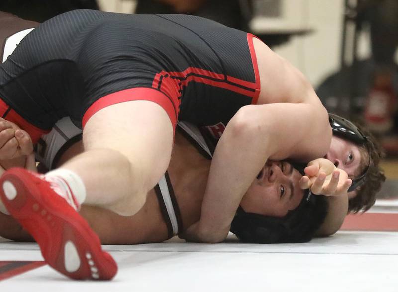 Huntley’s Waylon Theobald pins Jacobs’ Brian Ayala during the 190—pound match of a Fox Valley Conference wrestling meet on Thursday, Dec. 11, 2025, at Huntley High School.