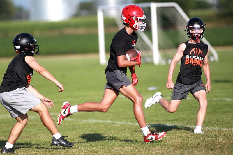 Yorkville’s A.J. Divito carries the ball during a 7 on 7 football tournament on Tuesday, July 15, 2025 at Kaneland High School in Maple Park.