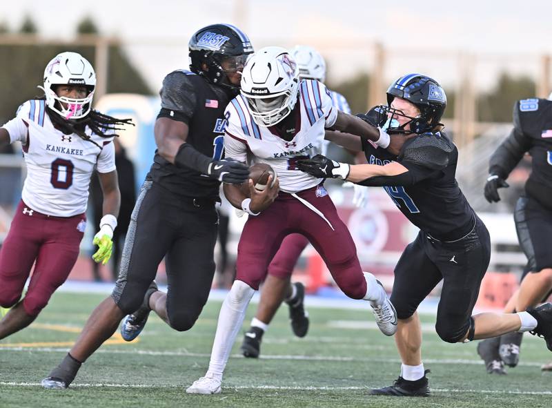 Lincoln Way East's Jacob Alexander (11) and Jacob Onik (44) tackle Kankakee's Kymani Billings (8) during the non-conference game on Friday, September. 05, 2025, at Frankfort.