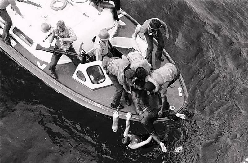 Sten Johnson of Woodstock, in the water, rescues a wounded Marine from the waters off Cambodia's Kho Tang island during the Mayaguez incident in May 1975 -- the last battle of the Vietnam War.