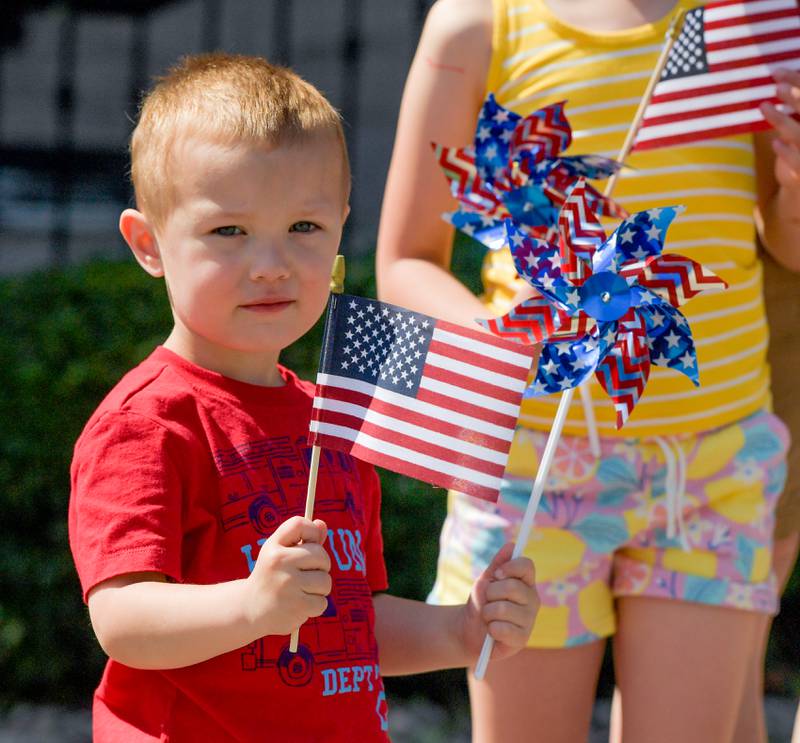 Charlie Muzzey, 3 waves an American Flag during the St. Charles Memorial Day Parade on Monday, May 29, 2023.