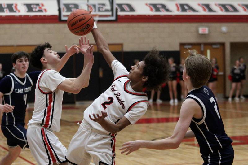 Huntley’s Omare Segarra (2) corrals the ball against Cary-Grove in varsity boys basketball at Huntley Friday.
