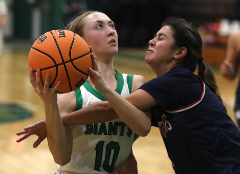 Alden-Hebron's Olivia Klein is fouled by Woodlands Academy's Faith Guerra as Klein drives to the basket during a nononference girls basketball game on Thursday, Jan. 29, 2026, at Alden-Hebron High School in Hebron.