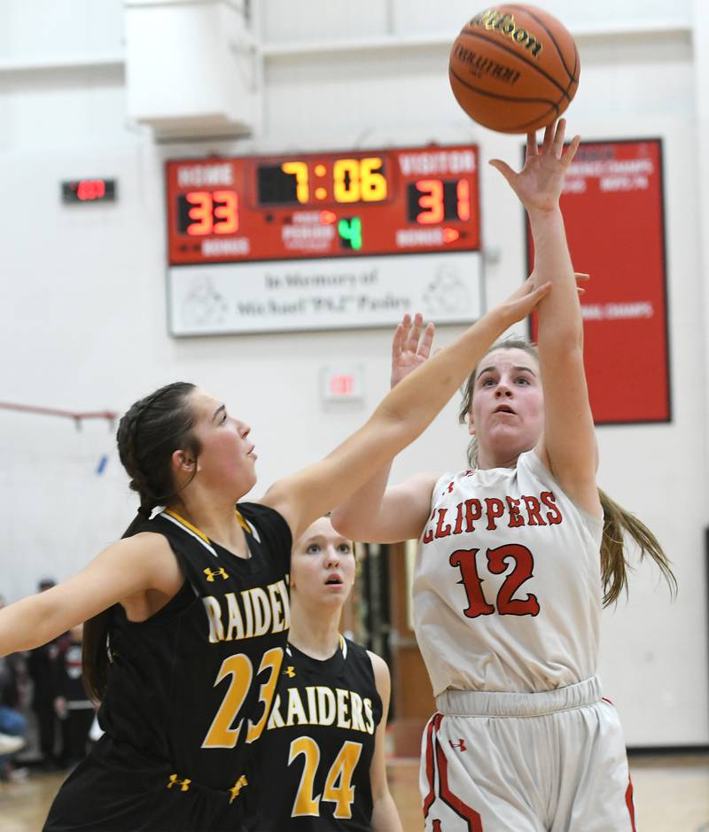 Amboy's Addison Pertell (12) shoots as AFC's Brianna Gonnerman (23) during Tuesday action against AFC at the 1A Amboy Regional.