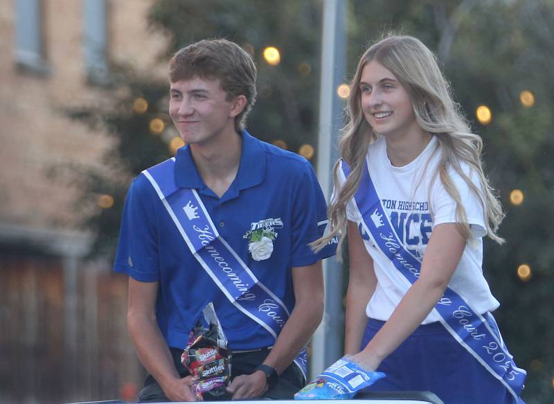 Senior court attendants Avery Waca and Jackson Mason ride during the Princeton High School homecoming parade on Thursday, Sept. 25, 2025 along South Main Street in Princeton .