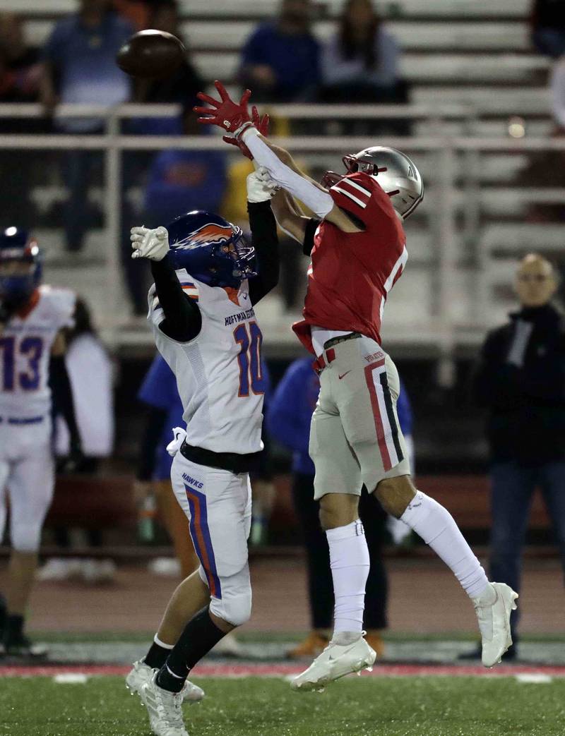 Hoffman Estates' Brett Phillips, (10) tries to block the view of Palatine's Thomas Coroneos (5)  Friday October 21, 2022 in Palatine.