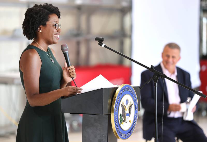 U.S. Rep. Lauren Underwood, D-Naperville, speaks as DeKalb mayor Cohen Barnes looks on Tuesday, Aug. 23, 2022, during a town hall meeting in one of the hangers at the DeKalb Taylor Municipal Airport.
