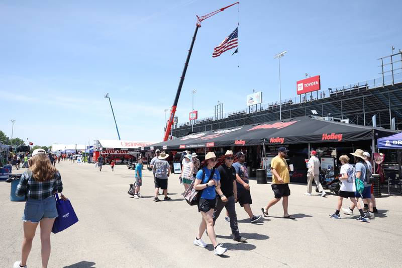 Race fans walk along the row of merchandise tents at the NHRA’s Gerber Collision and Glass Route 66 Nationals at Route 66 Raceway on Sunday, May 19, 2024 in Joliet.