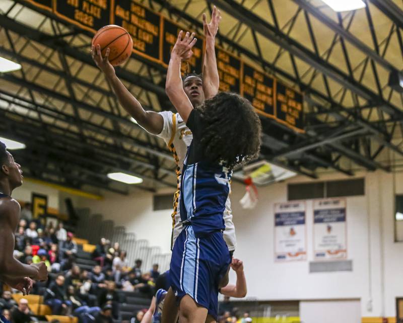 Joliet West's Aamir Shannon (0) puts up a as shot over 
Plainfield South's Isaiah Robertson (33) during their basketball game between Plainfield South at Joliet West, Feb 2, 2026 in Joliet.