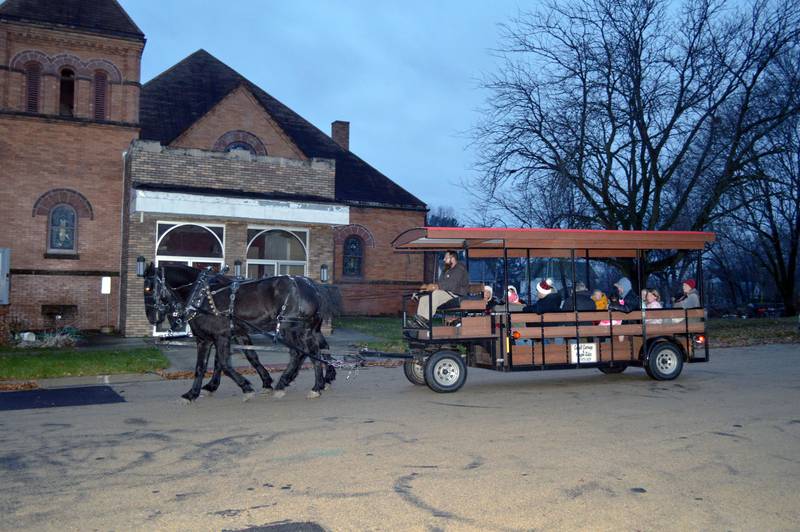 The Cargill Horse and Wagon Rides heads east along West Mason Street on Saturday, Dec. 2, 2023. The horse-drawn rides were one of the activities available as part of the fifth annual Polo Christmas Festival.