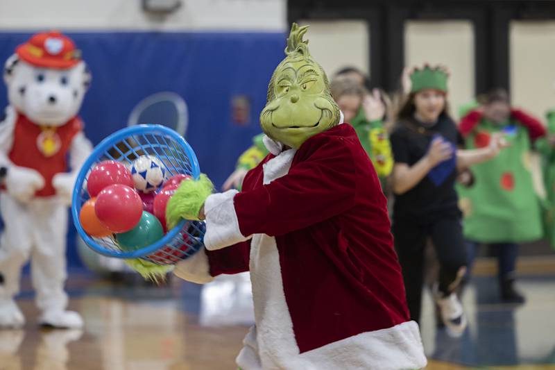 Grinch fires off a basket of balls at the start of the dodgeball fun. The event was moved to the RFMS gym due to the cold weather.