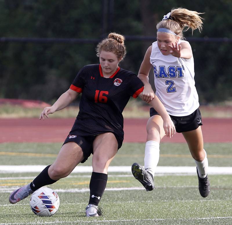 Libertyville’s Shea Krakowski kicks the ball away from Lincoln-Way East's Kara Waishwell during the IHSA Class 3A state third-place match at North Central College in Naperville on Saturday, June 3, 2023.
