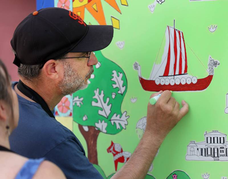 Mike Litwin, from Geneva, works on the Geneva Chamber of Commerce’s paint-by-number community art project Saturday, July 26, 2025, during at the Geneva Arts Fair on Third Street in Geneva.