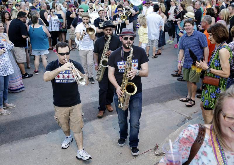 Members of the Four Star Brass Band play a set Friday during the New Orleans North celebration in downtown Joliet.