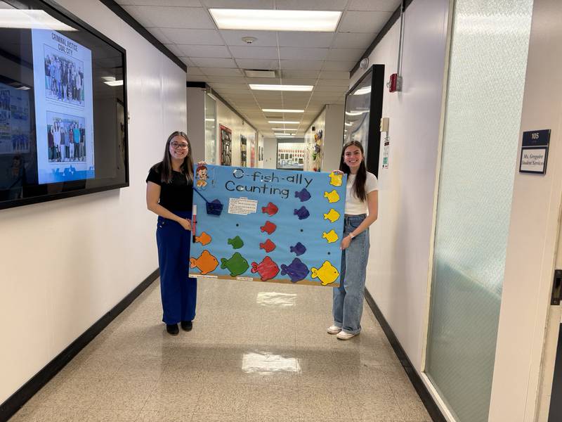 Valeria Garcia (left) and Kira Dergo with the presentation that earned them a trip to Atlanta for the SkillsUSA national competition.