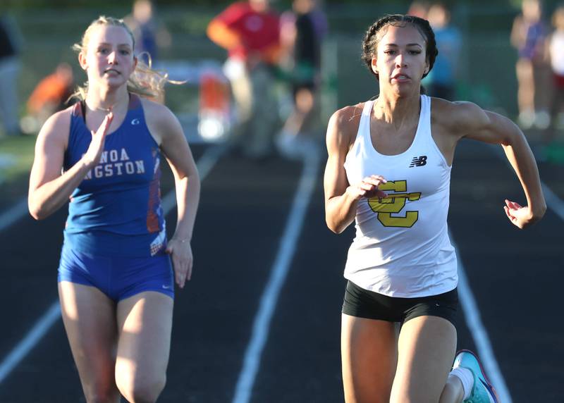 Carmel’s Maliyah Mays (right) finishes just ahead of Genoa-Kingston’s Haley Oranger in the 100 meters Friday, May 15, 2026, during the Class 2A girls track sectional at Genoa-Kingston High School.