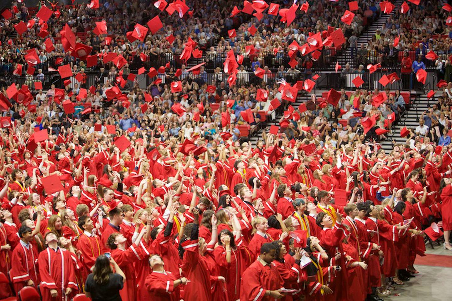 Yorkville High School Graduates throw their caps in celebration at the  Commencement Ceremony at NIU Convocation Center on Friday, May 16, 2025 in DeKalb.