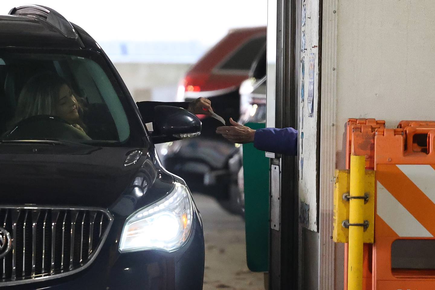 A driver pays for parking at the Ottawa Street parking deck on Wednesday Mar. 6th, 2024.