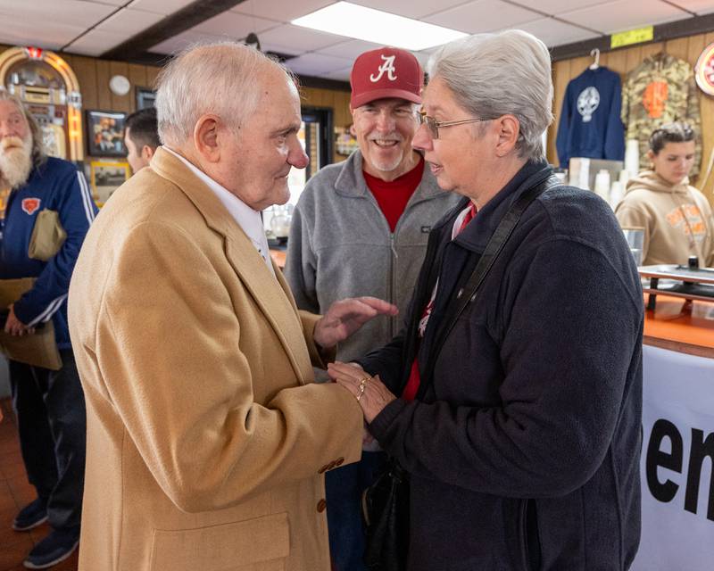 Sam Leone holds hands of Cathy Hitchins as Gary Hitchins watches on at Sam’s retirement celebration on Saturday, October 25, 2025 at the Rootbeer Stand in Oglesby.