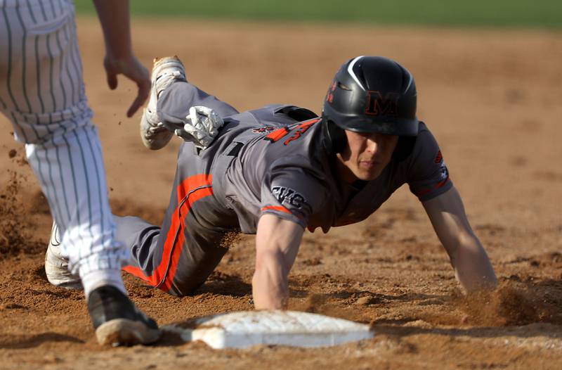 McHenry's Landon Clements dives bask to first base during a Fox Valley Conference baseball game against Crystal Lake South on Monday, April 13, 2026, at Crystal Lake South High School.