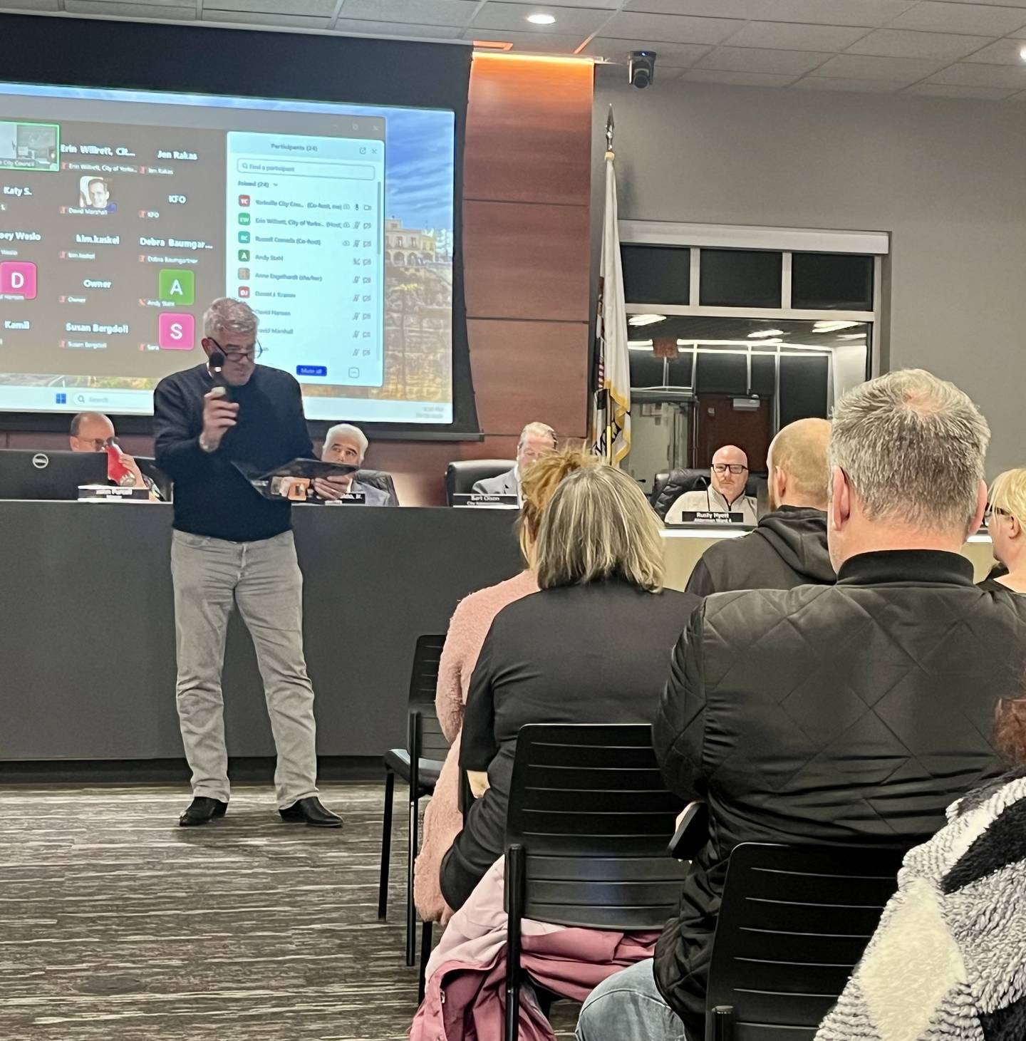 Resident John Bryan of Yorkville demonstrates for the city council the expected noise of the 1,037 acre Project Cardinal data center on Oct. 28, 2025.