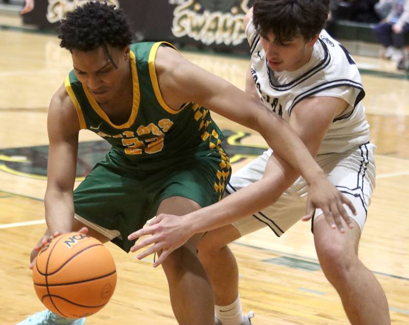 Crystal Lake South’s David McFadden, left, works past Cary-Grove’s Brady Elbert in boys IHSA Class 3A Regional Championship basketball on Friday, Feb. 27, 2026, at Crystal Lake South High School in Crystal Lake.