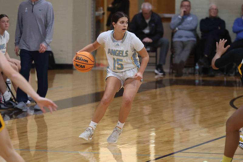 Joliet Catholic’s Allison Lesters works the ball midcourt against Marian Catholic on Monday, Dec. 9, 2024 in Joliet.