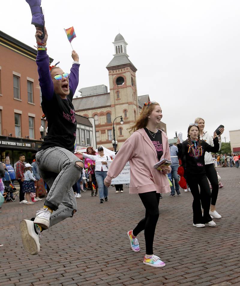 A girls kicks up her heels as she takes part in the Woodstock PrideFest Parade Sunday, June 11, 2023, around the historic Woodstock Square.