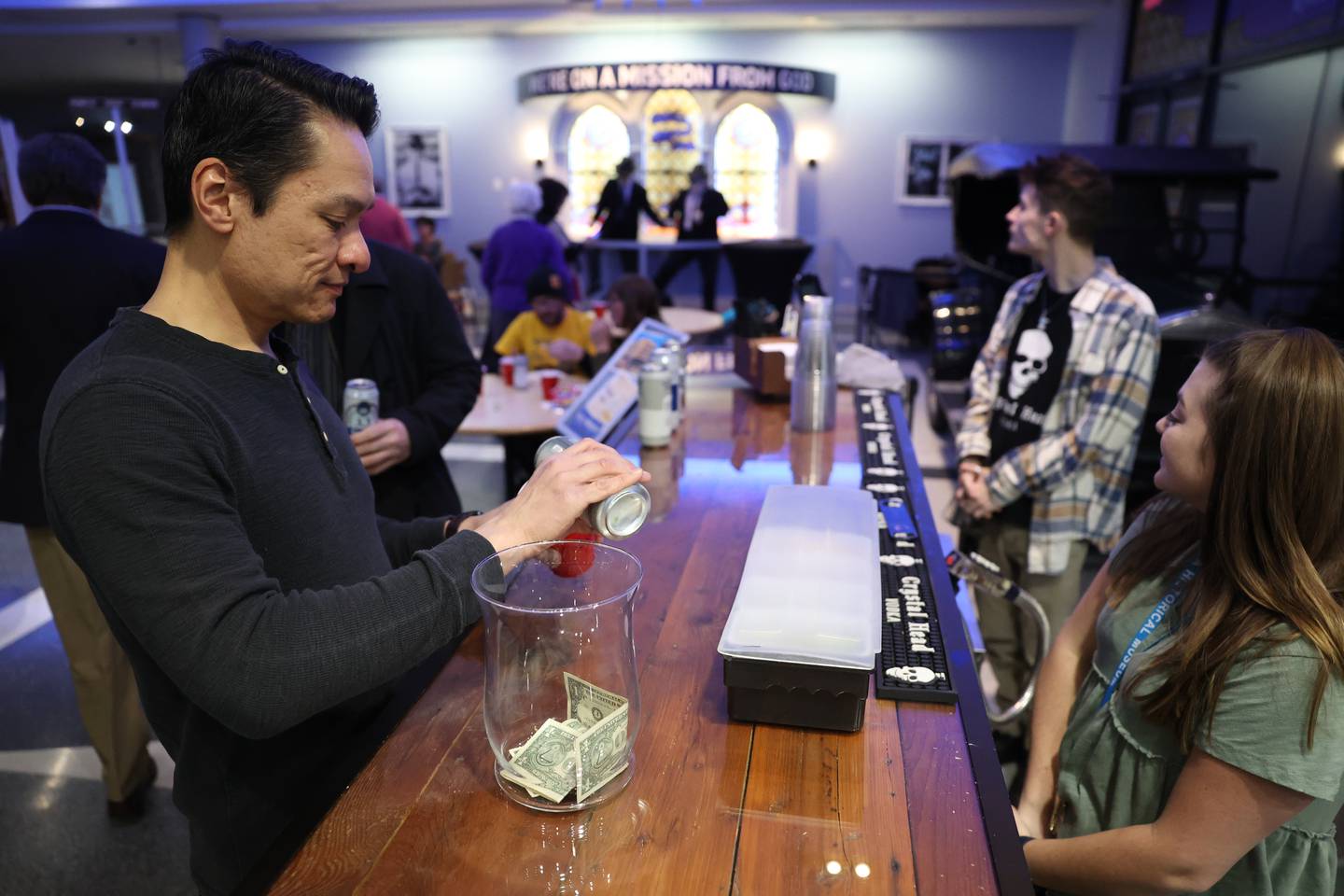 Chris Foray gets a drink from the bar at a kegger fundraiser to save the old Will County Courthouse at the Joliet Area Historical Museum on Friday, February 3rd.