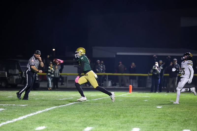 Bishop McNamara's Coen Demack runs in a touchdown during Bishop McNamara's 38-14 victory over Herscher in the IHSA Class 3A first round playoff game on Friday, Oct. 31, 2025.
