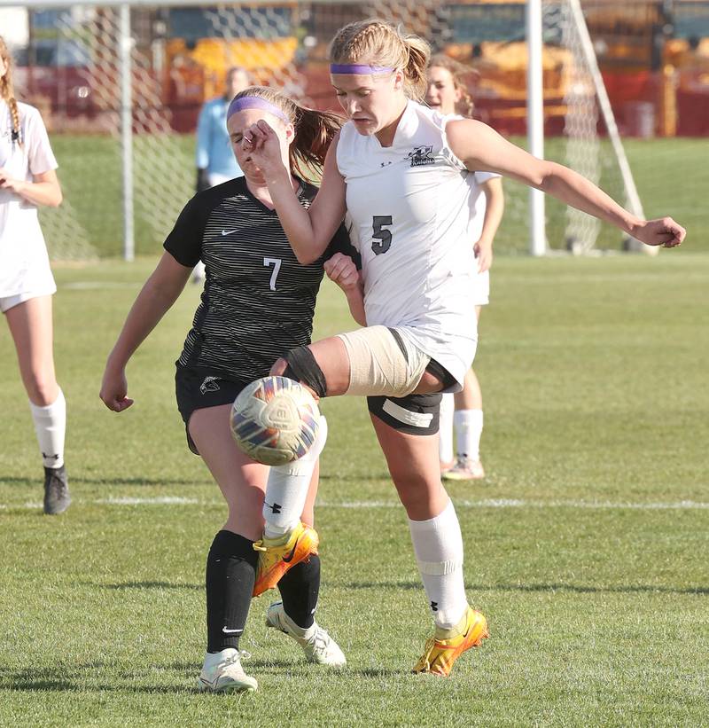 Kaneland's Brigid Gannon kicks the ball away from Sycamore's Peyton Wright Friday, April 28, 2023, during their game at Sycamore High School.