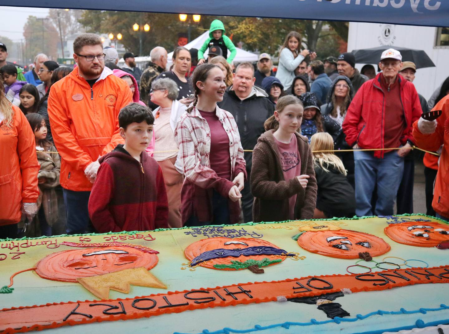 Visitors gather for the cake cutting Wednesday, Oct. 25, 2023, on North Maple Street adjacent to the DeKalb County Courthouse during the Sycamore Pumpkin Festival. The cake was donated by the Sycamore Hy-Vee.