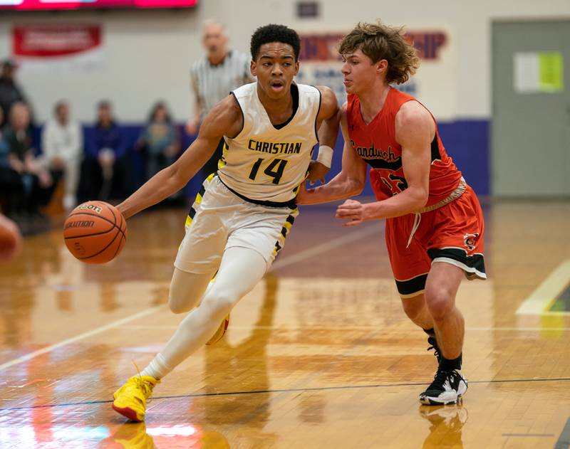 Yorkville Christian's David Douglas Jr (14) drives to the basket against Sandwich’s Austin Marks (22) during the 59th Annual Plano Christmas Classic basketball tournament at Plano High School on Tuesday, Dec 27, 2022.