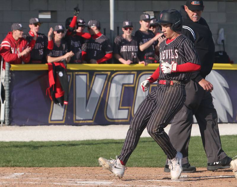 Hall's Geno Ferrari steps on home plate to score the teams first run on Monday, March 31, 2025 at Schweickert Stadium in Peru.