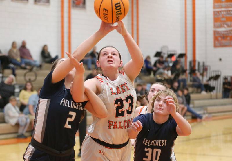 Fielecrest's Pru Mangan and teammate Madeline Thessfeild battle for a rebound with Flanagan-Cornell/Woodland's Chandler Weber during the Falcon-Irish Thanksgiving Tournament on Monday, Nov. 18, 2024 at Flanagan High School.