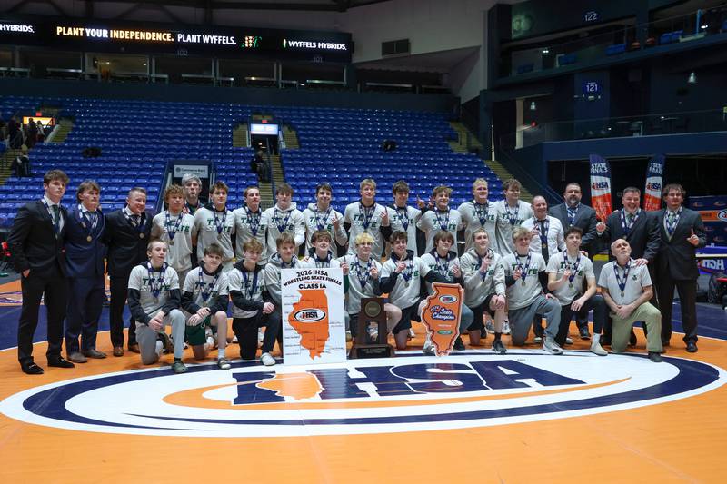 Coal City wrestlers and coaches pose with the IHSA Class 1A Dual Team State championship trophy following their victory over Vandalia on Saturday, Feb. 28, 2026.