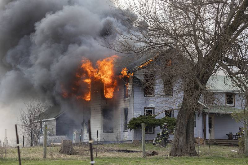 Firefighters battle a house fire Monday, April 14, 2025, at 1308 Harmon Road.