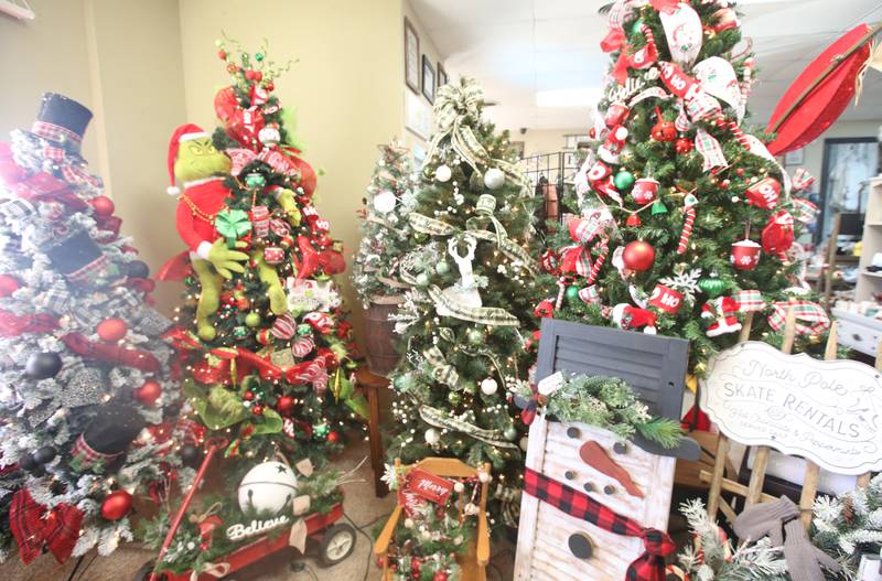 A view of a collection of Christmas trees on Tuesday, Nov. 12, 2024 at Upscale Resale in Spring Valley.  For over 17 years the business has hosted a yearly Christmas Tree and Decor Auction, featuring unique items and themed trees that customers can add to their collections. The items will be on display in the window of the business, located at 214 W. St. Paul St. in Spring Valley. The auction takes place Thursday from 10a.m.-2p.m. Proceeds from the auction will go toward Upscale’s Helping Hands Charity to help out local communities.